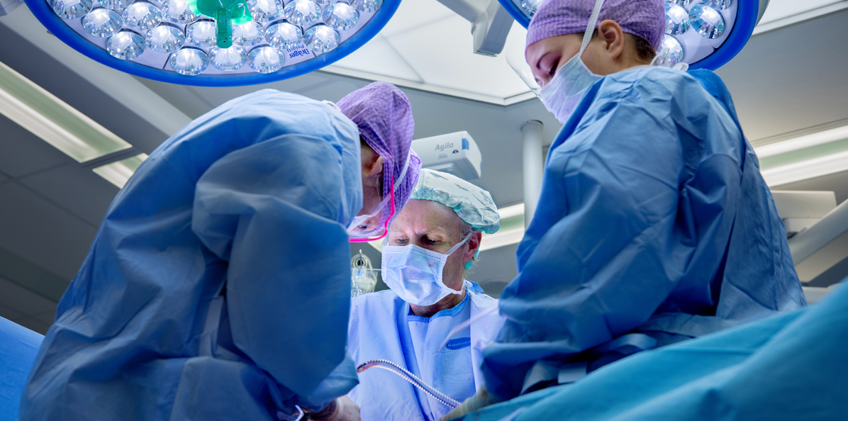 a group of surgeons in a operating room